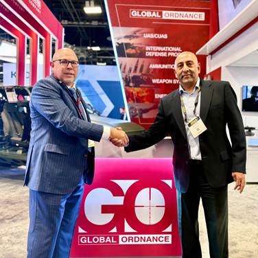 Representatives shake hands at a Global Ordnance booth during AUSA 2026.